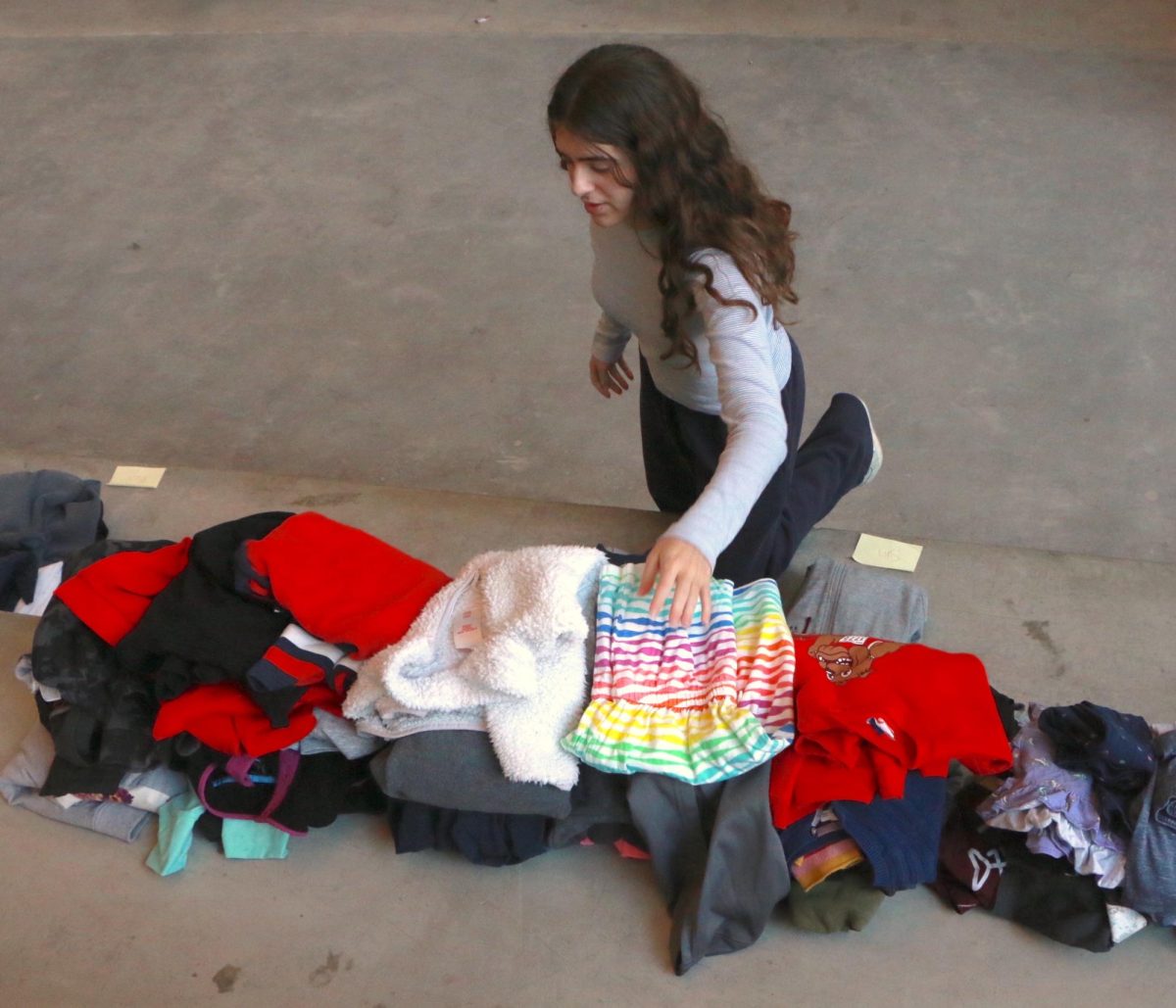 Students sorting clothes donated in a drive to The Clothesline